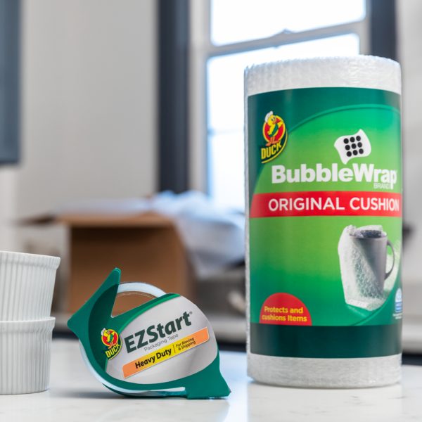 A roll of bubble wrap and a roll of packing tape in a dispenser