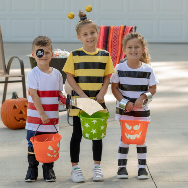 Three children wearing Halloween costumes
