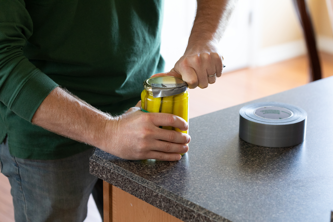 Open a pick jar lid using duct tape as a handle