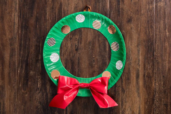 A wreath made out of green Duck Tape with a red Duck tape bow.