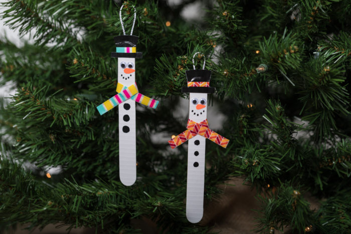 Popsicle stick snow men hanging in a tree.