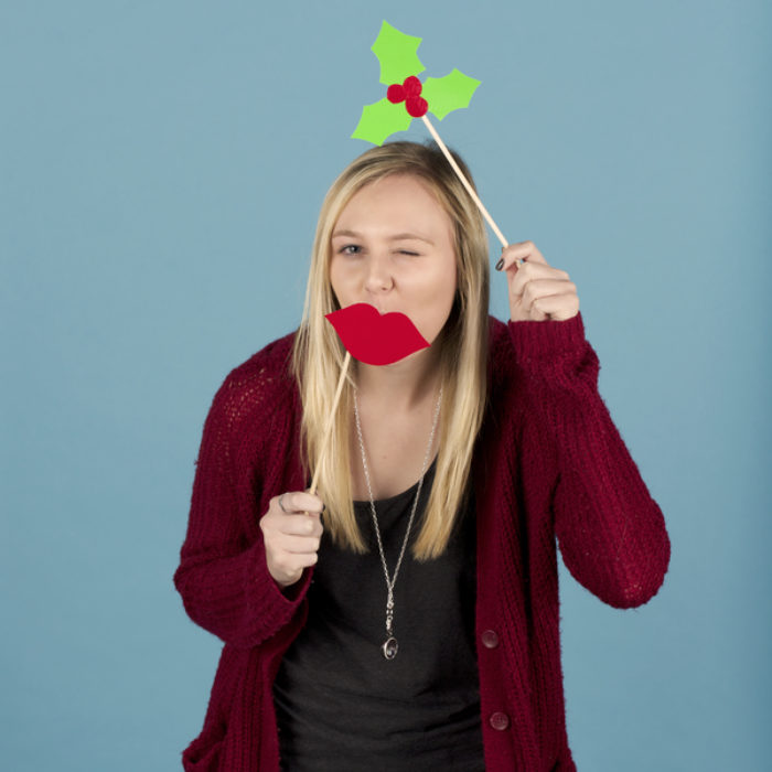 Woman posing with photo booth props made from Duck Tape