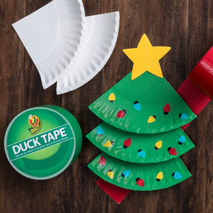 Paper plate Christmas trees next to a roll od Duck tape and white paper plates.