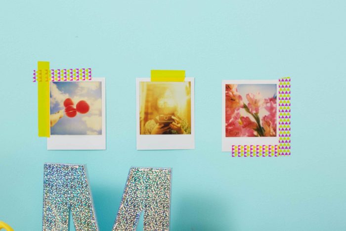 Three pictures on a wall framed with washi tape.