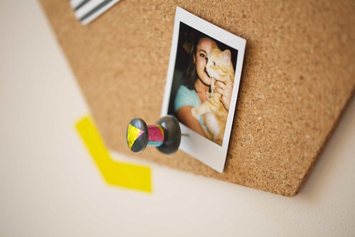 A cork board decorated with washi tape.
