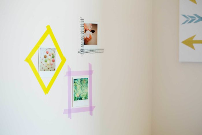 Washi tape framing pictures on a wall.