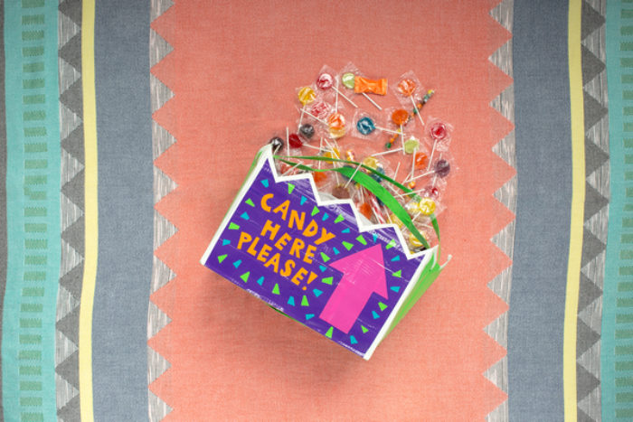 A bag full of candy, decorated with colored duck tape.