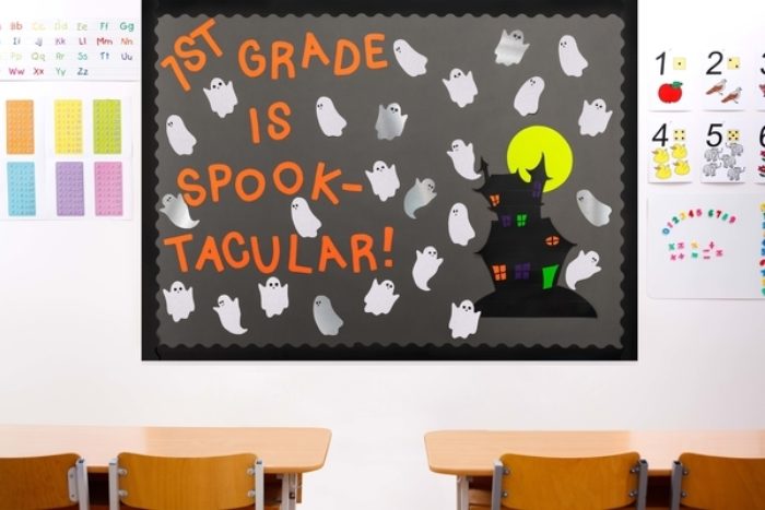 A bulletin board decorated with a spooky castle and ghosts.