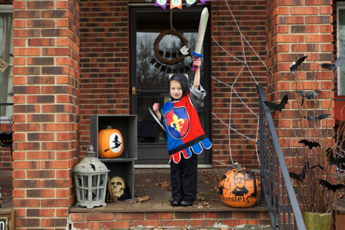 A child dressed up in a knight costume made out of Duck Tape.