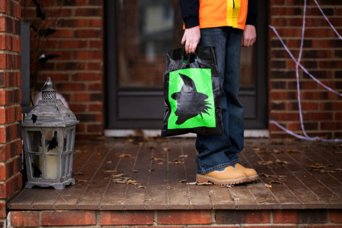 A black and green Trick or Treat bag decorated with colored Duck Tape.