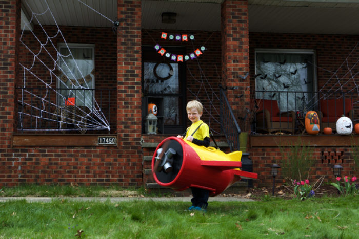 A child wearing a plane costume made out of Duck Tape.