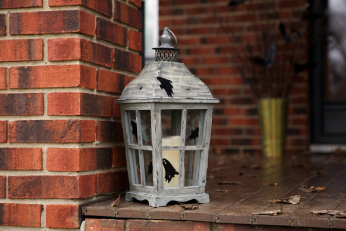 A lantern decorated with black Duck Tape bats.