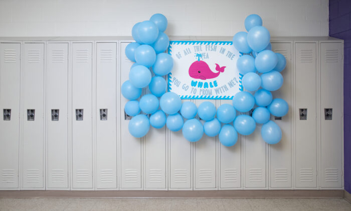 Promposal poster with blue balloons, pink whale and blue duct tape asking someone to prom.