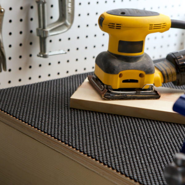 Black Supreme Grip placed beneath tools on a work bench