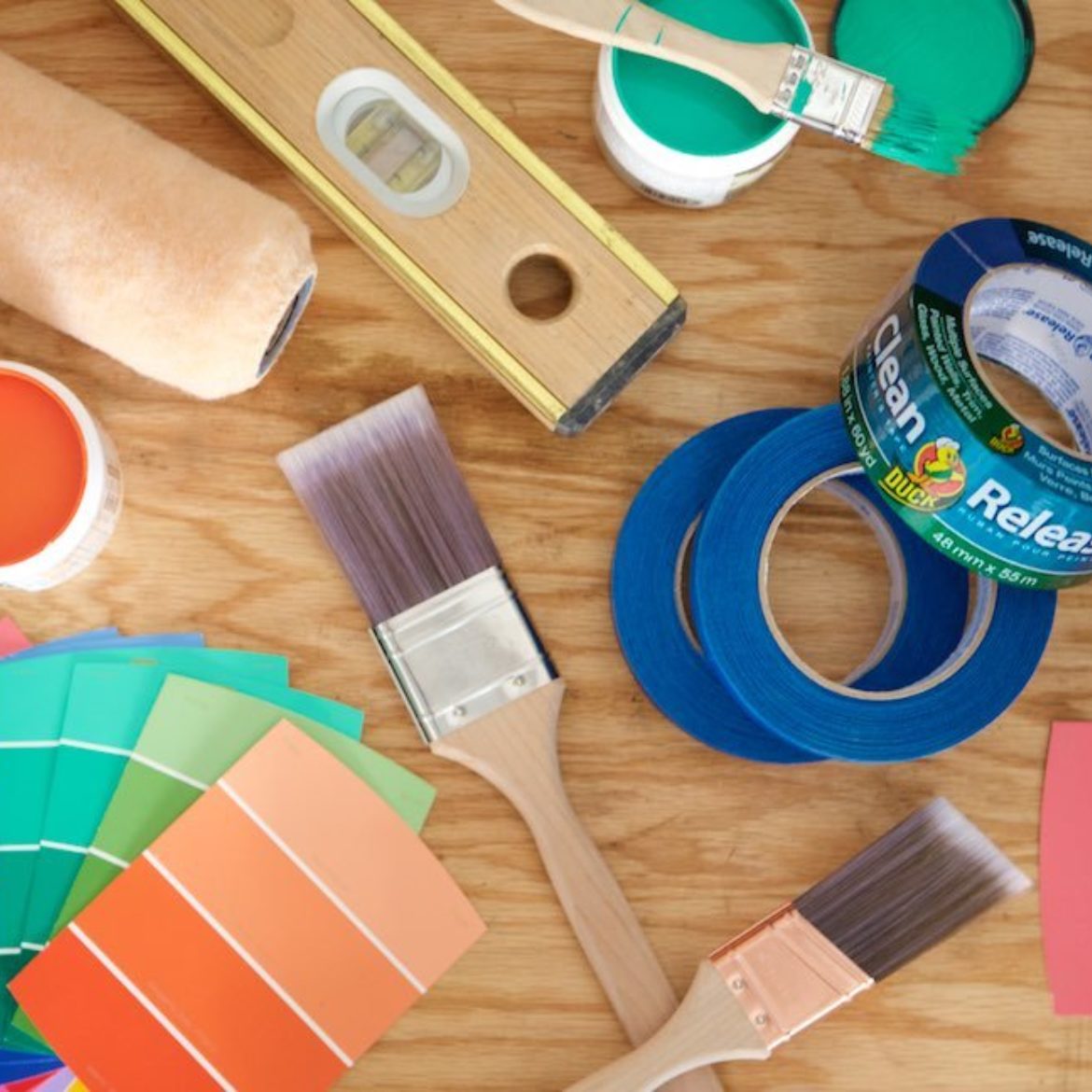 An assortment of brushes, rollers and paint swatches.