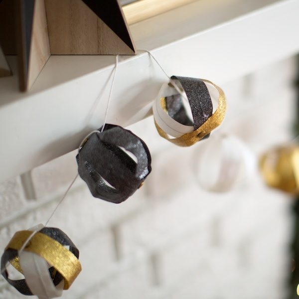 Completed Duck Glitter® Christmas Garlands hanging on a mantle