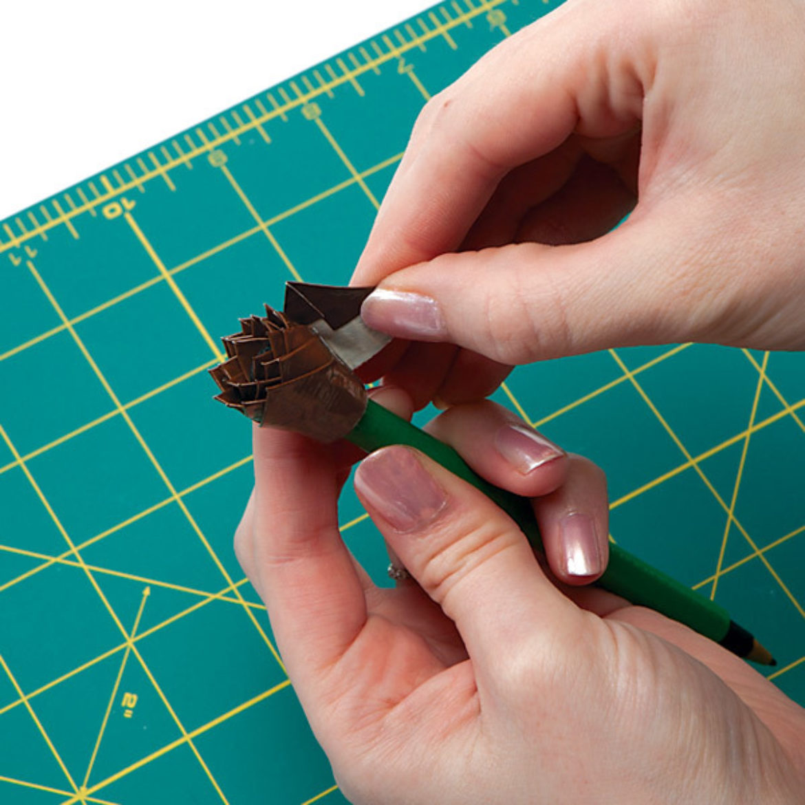 Pieces from the previous step overlapped and rolled onto the top of the pen to form the center of the flower