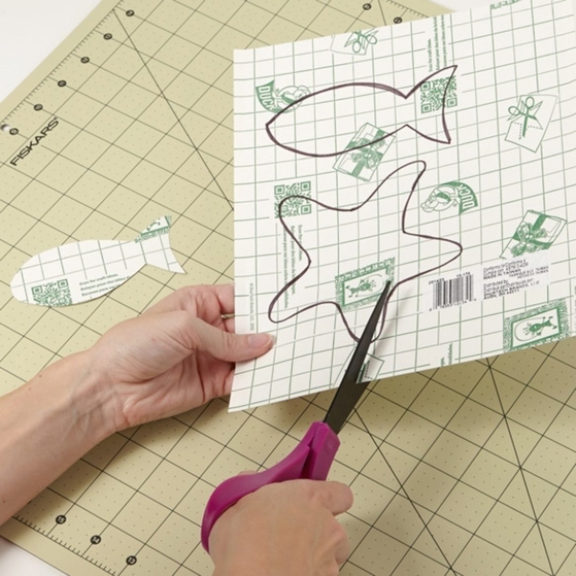 Fish shapes being cut out of Duck Prism sheet