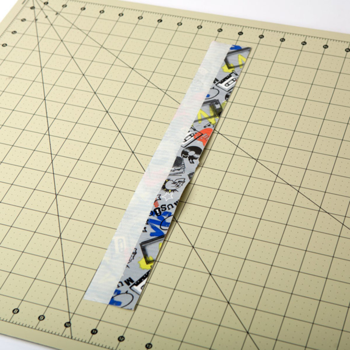 The two strips from the previous step placed on one side of the strip from step 2 so that half of the strip is sticky and the other half is double sided