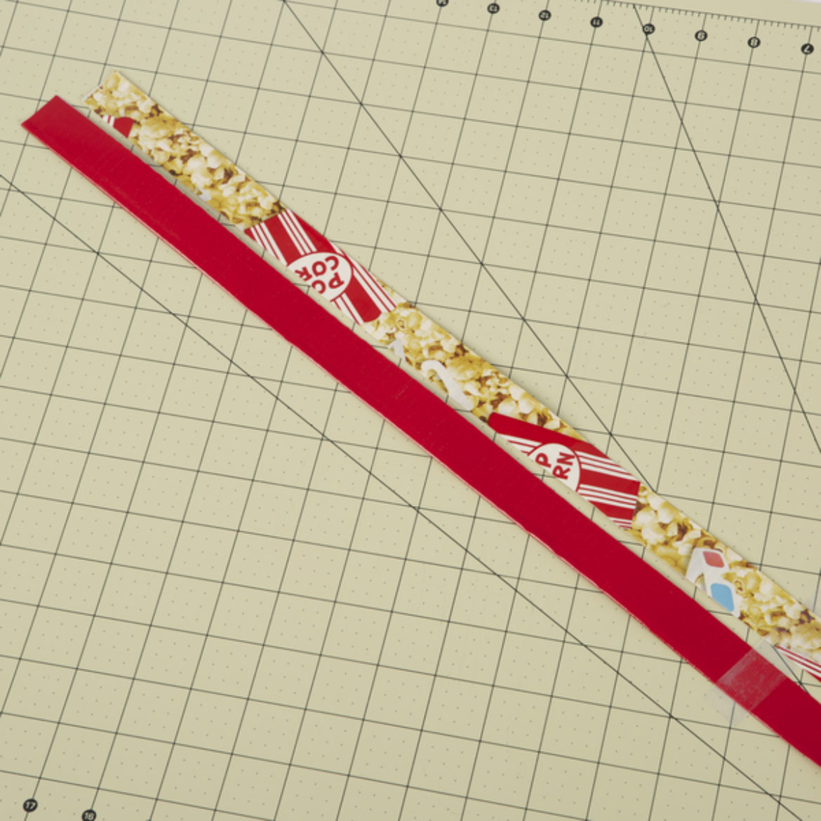 2 double sided strips of Duck Tape made by folding the strips of tape lengthwise