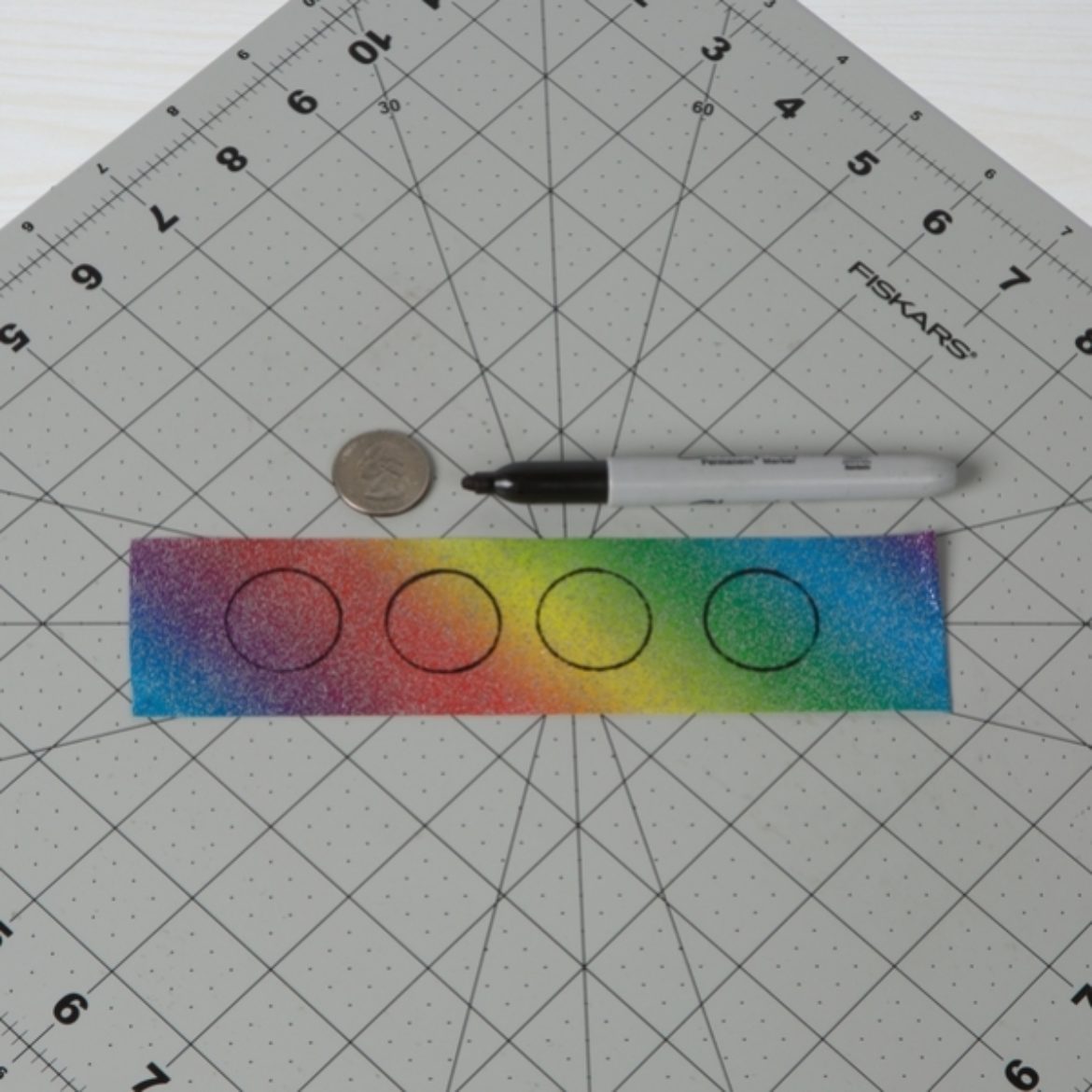 Circles traced on the tape from the previous step using a quarter as a template