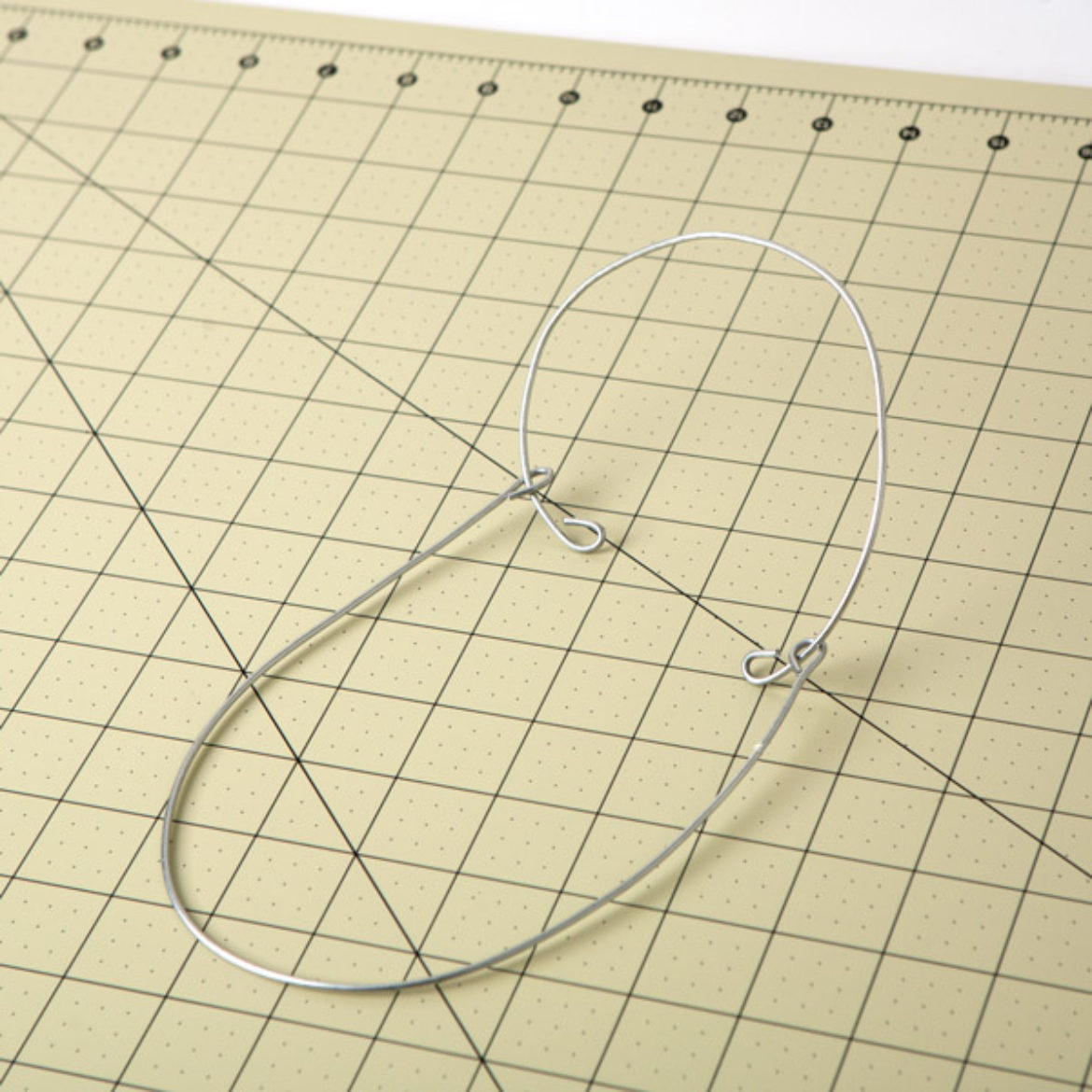 circular piece threaded through the looped ends of the U shaped piece