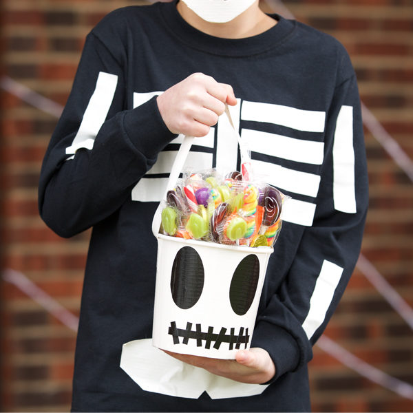 Child holding a completed Duck Tape® Halloween Bucket