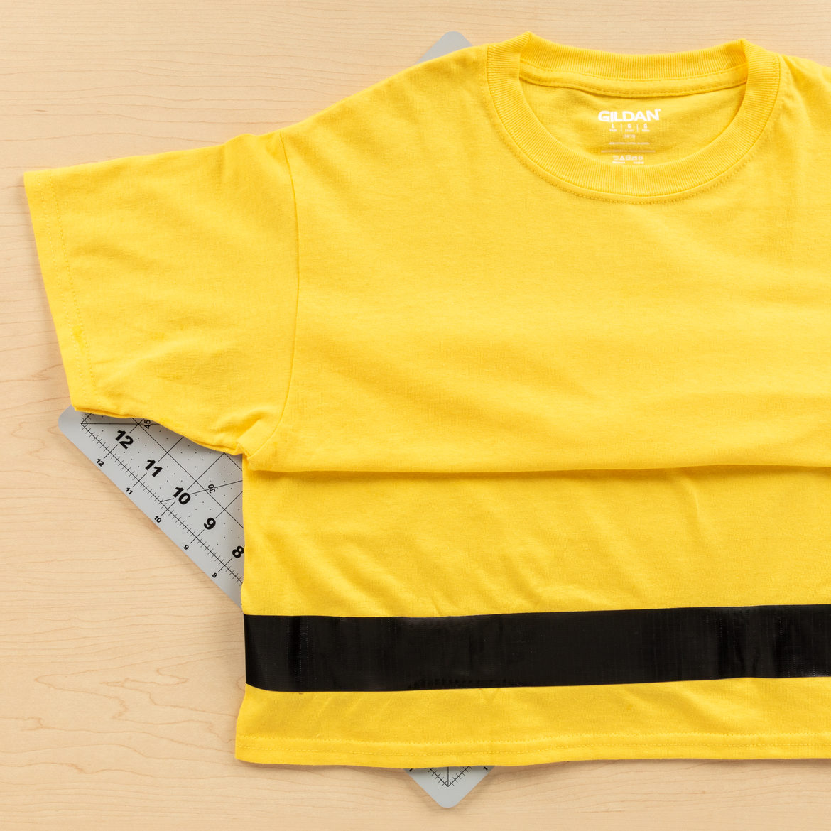 strips form the previous step attached to a yellow T-shirt
