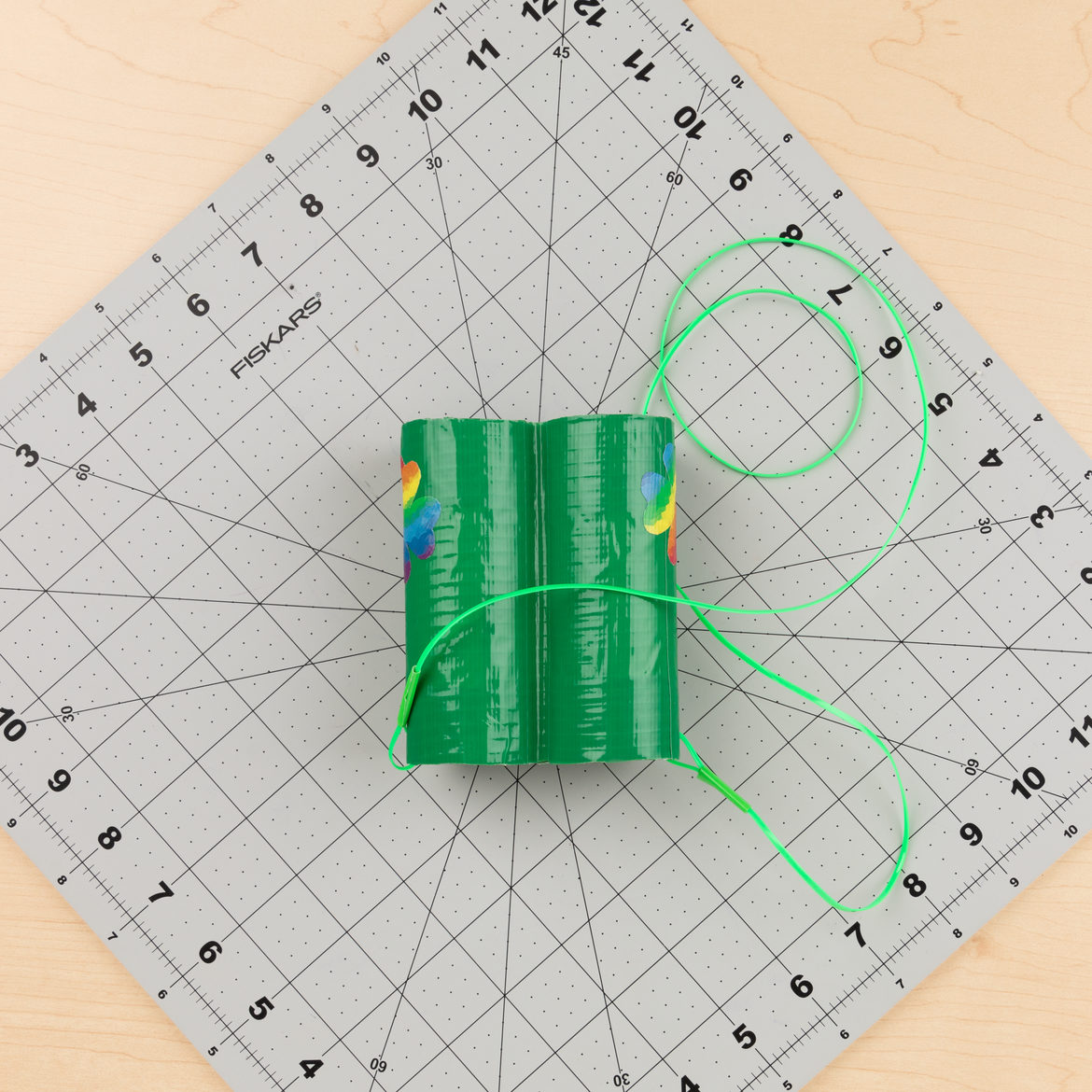 holes punched in the side of each roll, then string run through each to create a lanyard