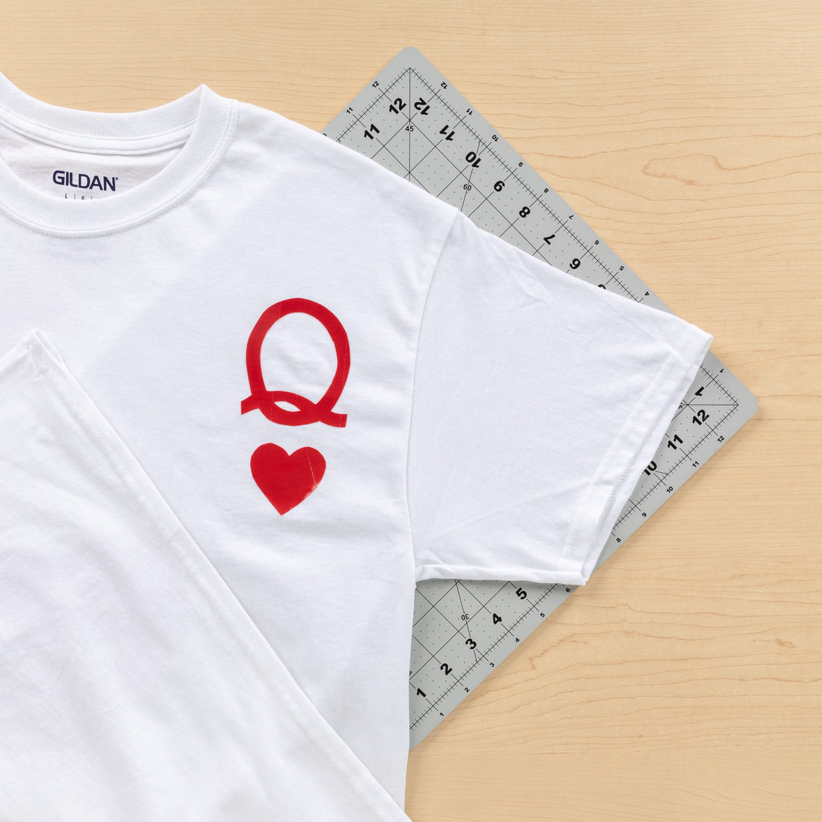 cut outs from the previous step attached to the T-shirt to resemble a playing card