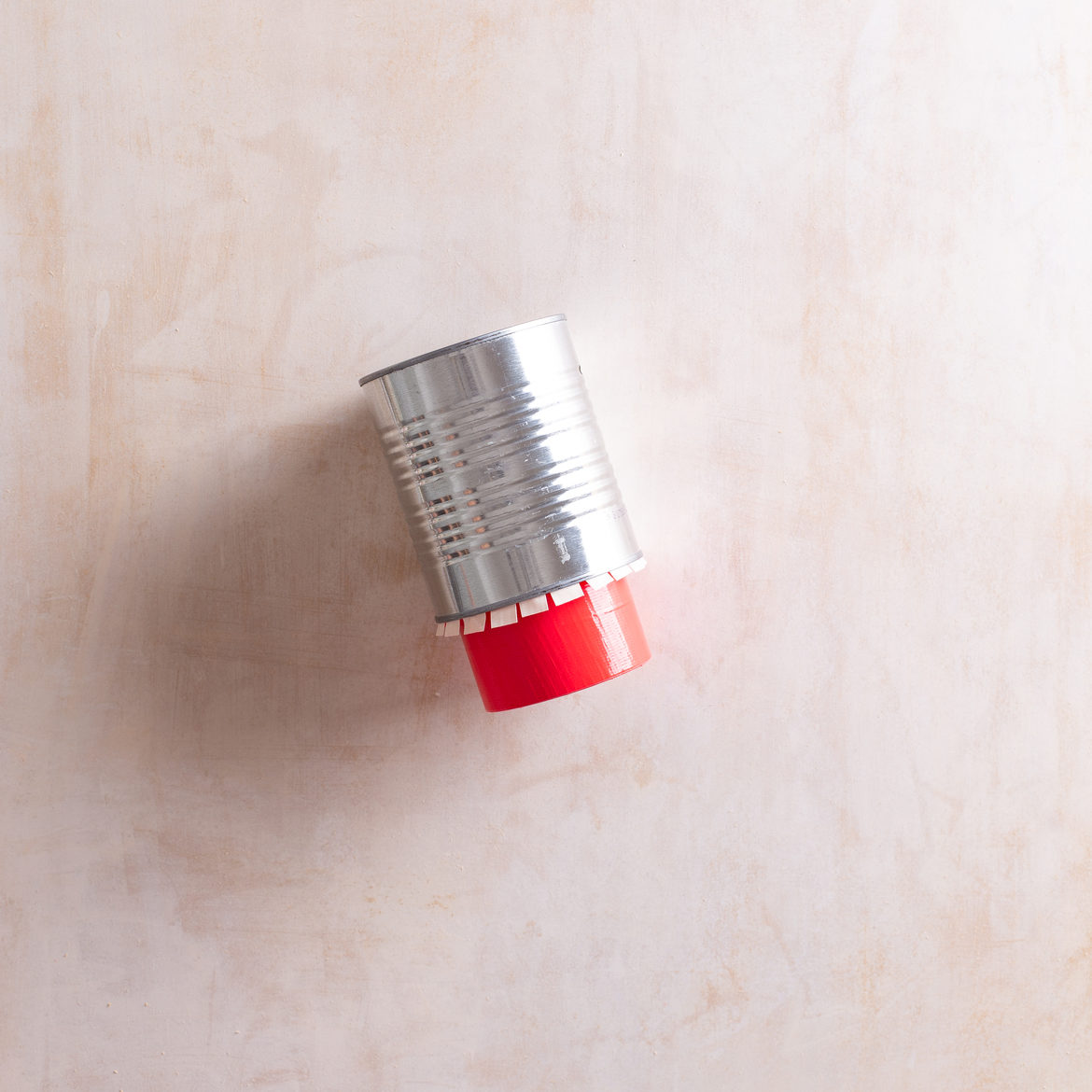 Empty can with tape roll sticking out bottom with tape tabs at the top