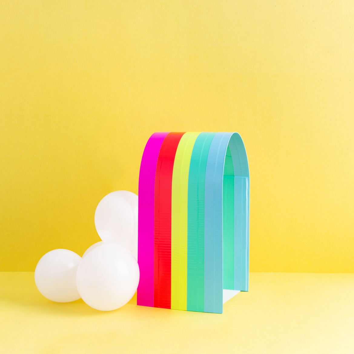 Balloons attached to the rainbow with hot glue