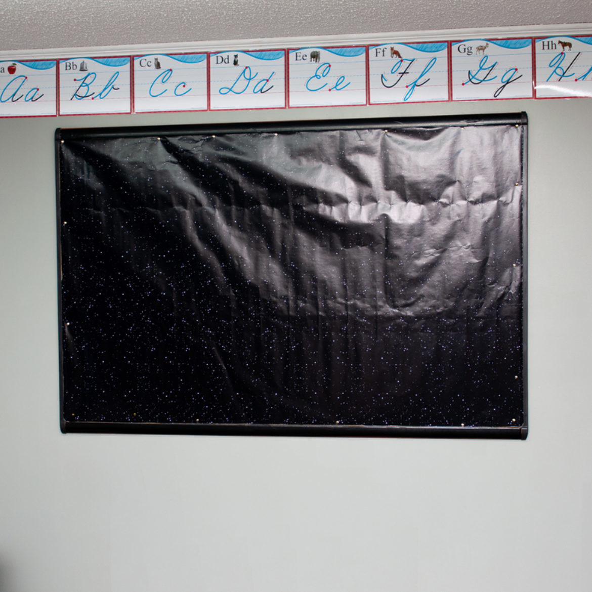 Bulletin board covered with black paper, by Crafts by Courtney.