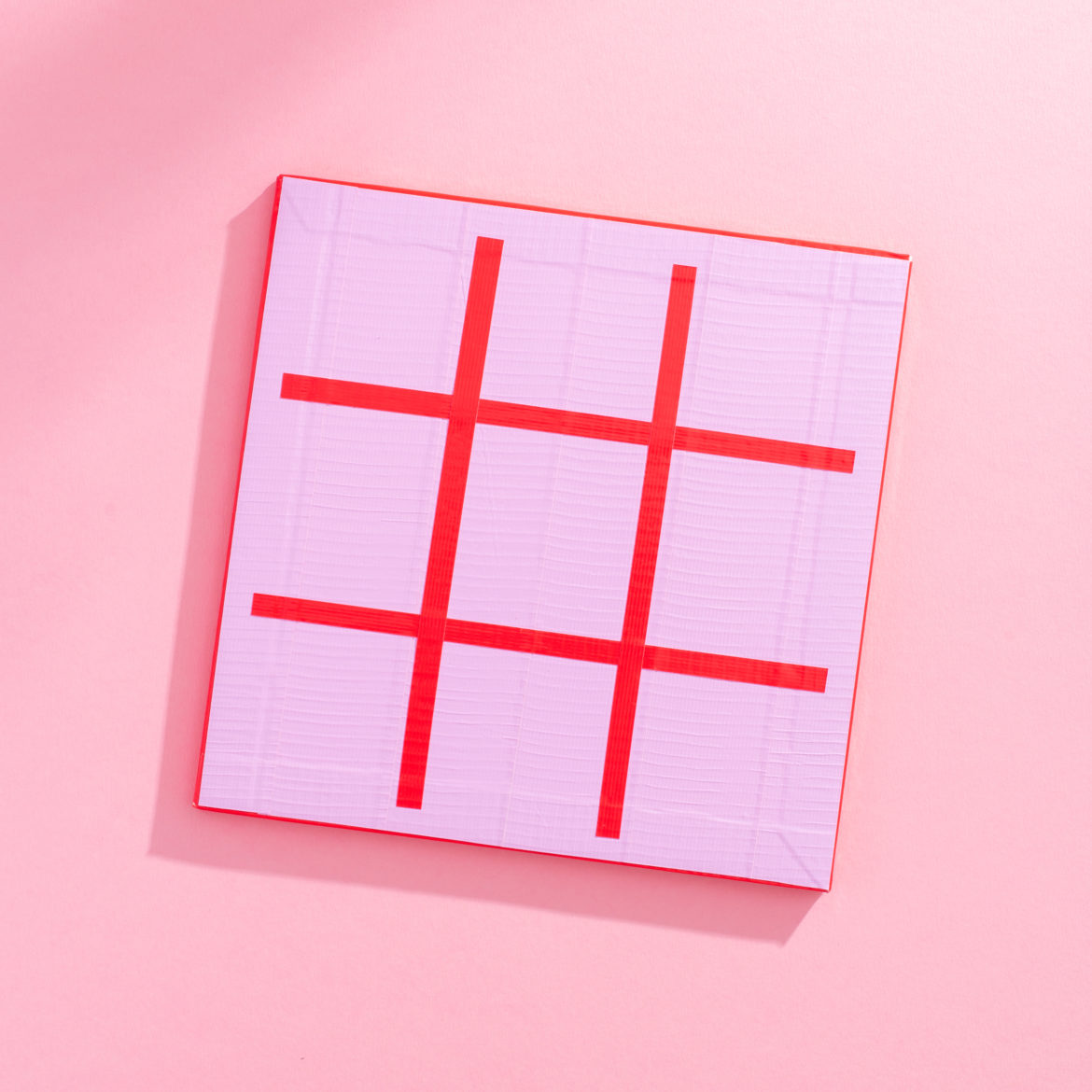Create a 3x3 grid with red Duck Tape on the surface of the foam squares
