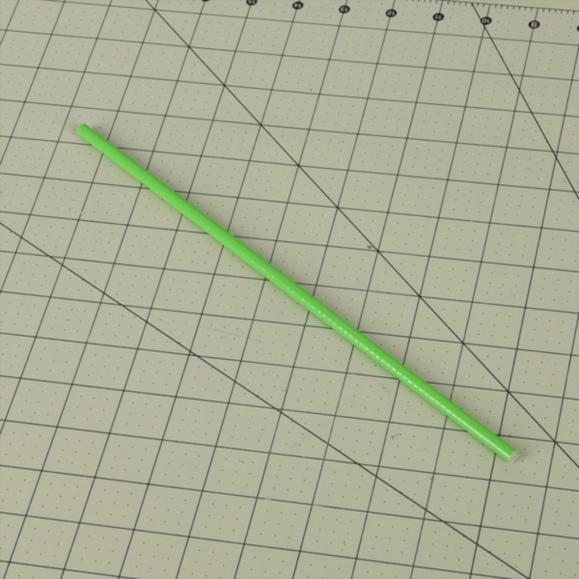 Dowel rod covered in green Duck Tape