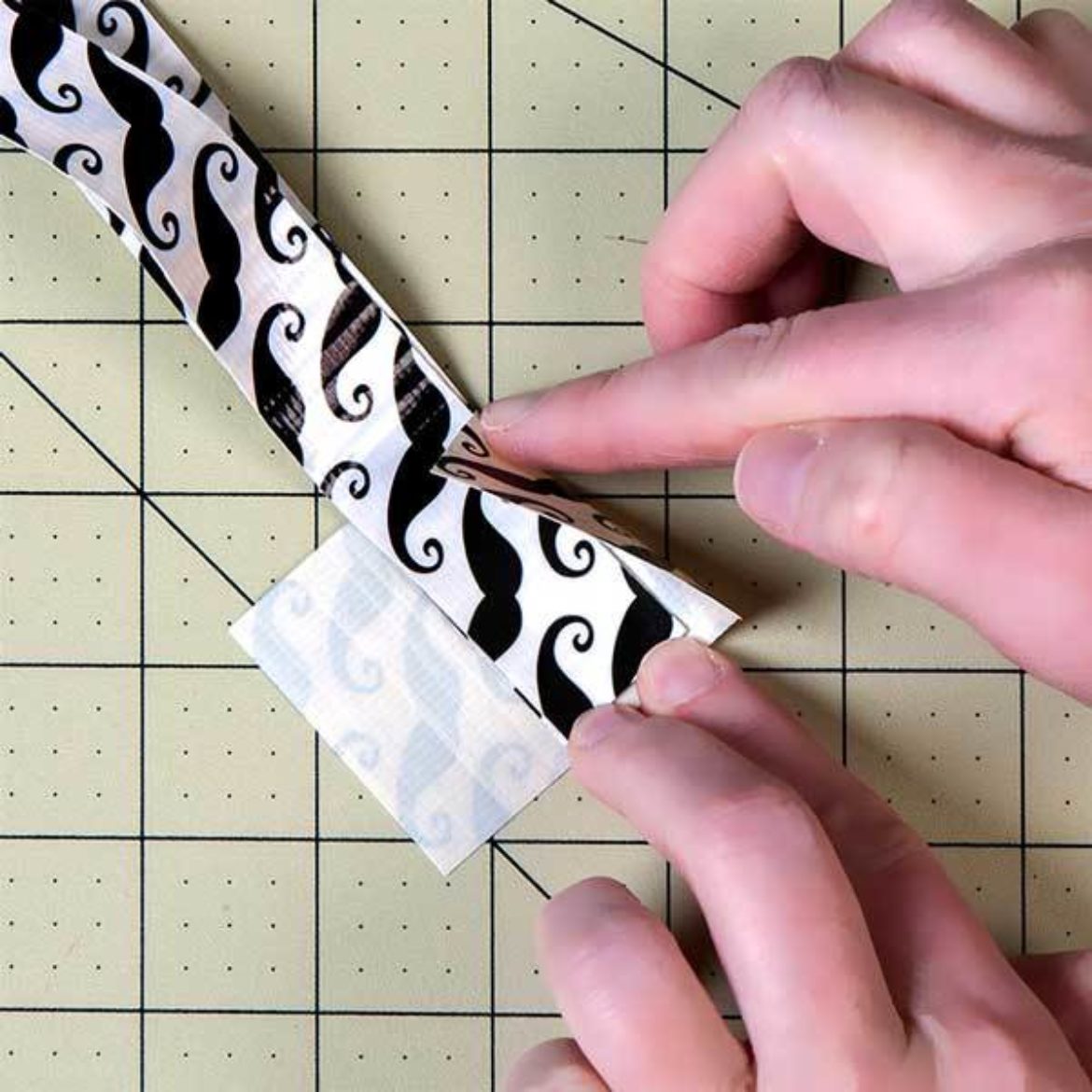 place the two ends of the strip from the previous step together so that they meet and tape them together