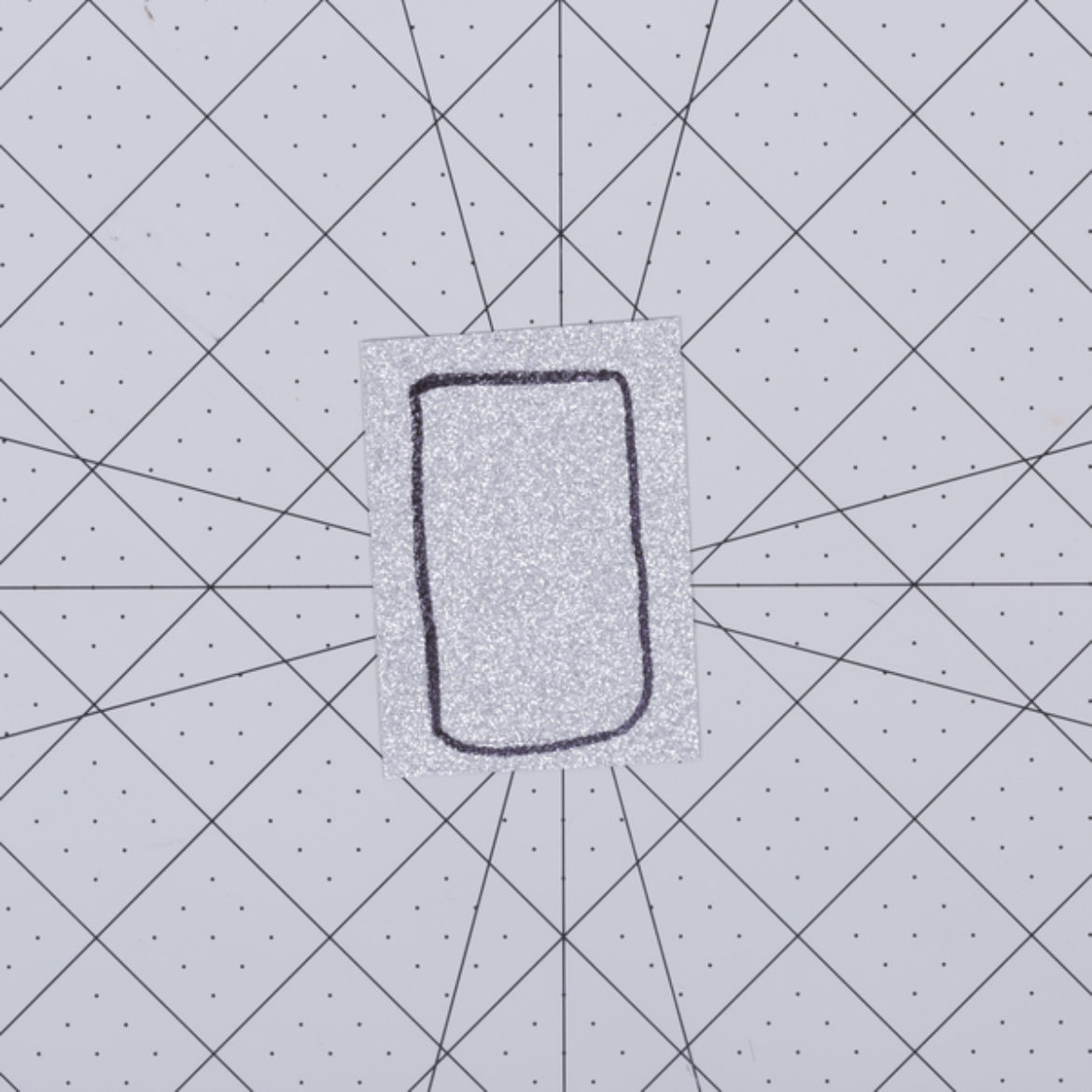 Top fuzzy part traced on a rectangle of glitter fabric