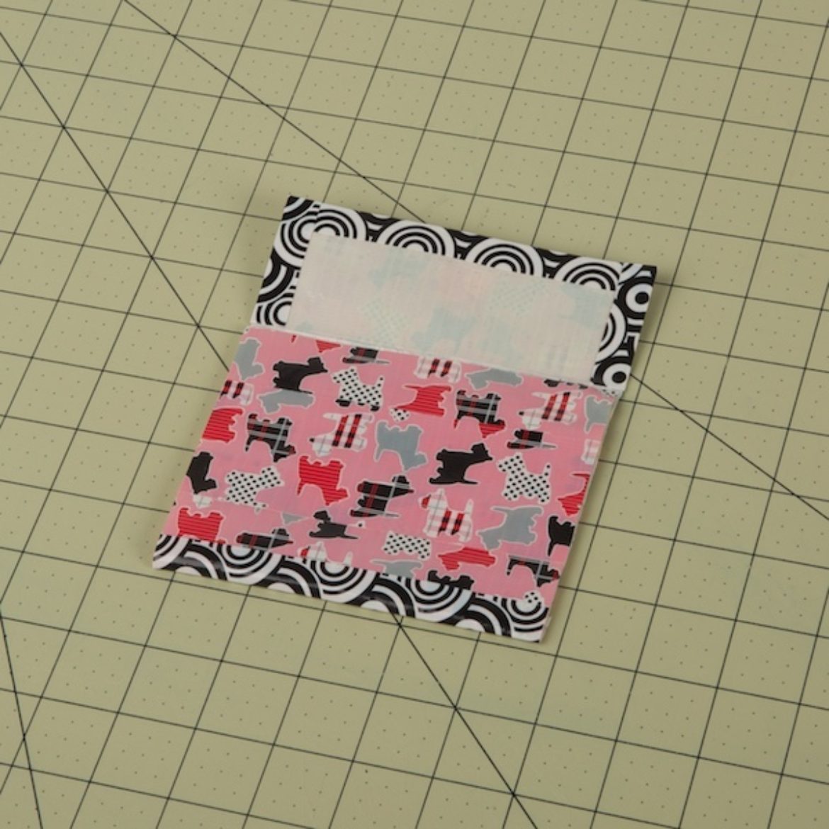 the largest piece folded over itself and taped to create a pocket with a flap