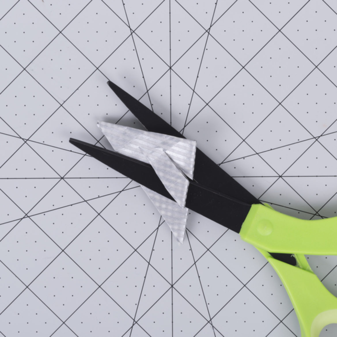 Square from previous step folded in half to make a triangle. Two cuts going half way across the triangle