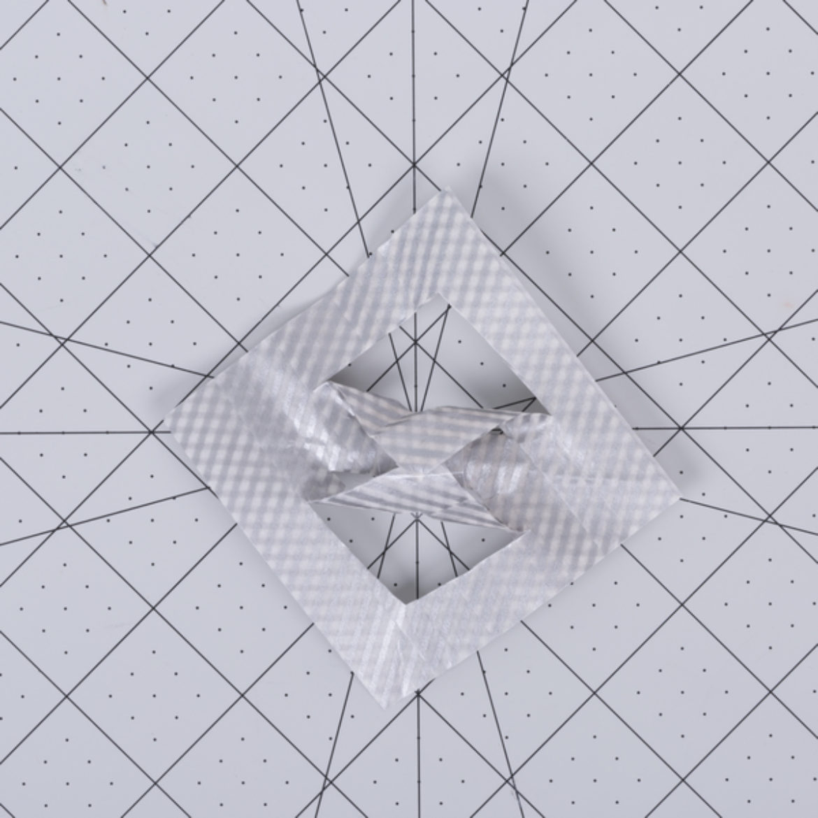 tape the middle, medium sized triangles together in the opposite direction as the previous step