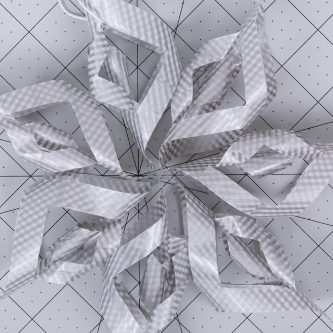 all of the points of the shapes made in the previous steps pointed inward, and facing the same direction to form a snowflake shape