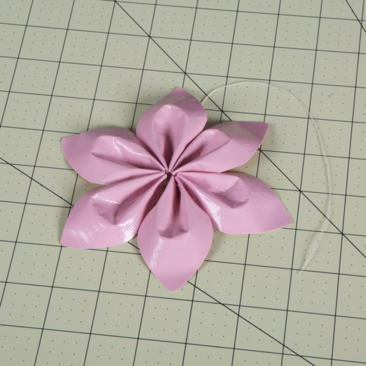 string pulled tightly to arrange the petals in shape