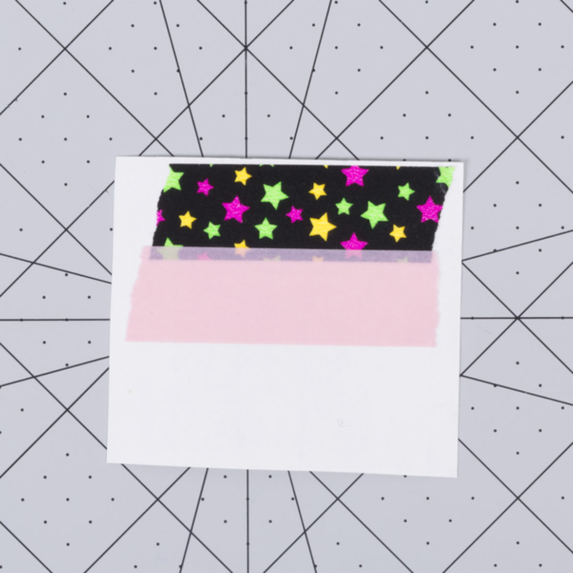 Two strips of Duck Washi Tape placed overlapping on a piece of contact paper
