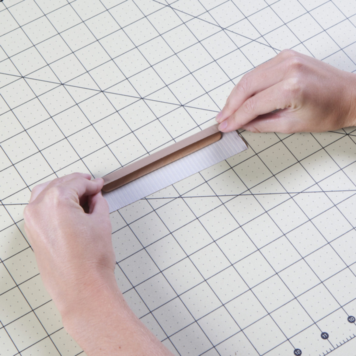 strip of Duck Tape folded over a craft stick so that each end reaches the middle of the stick